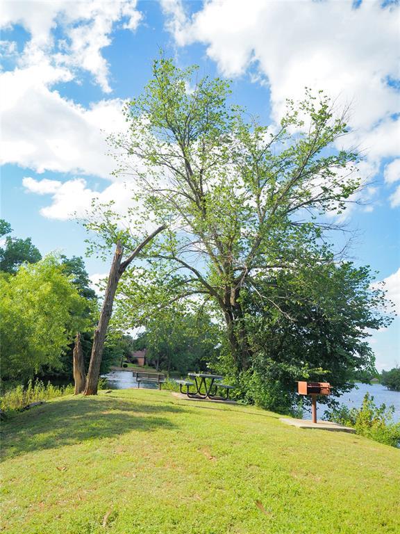 1209 Fox Bluff Ct, Edmond, OK 73034 - view of green lawn with a water view