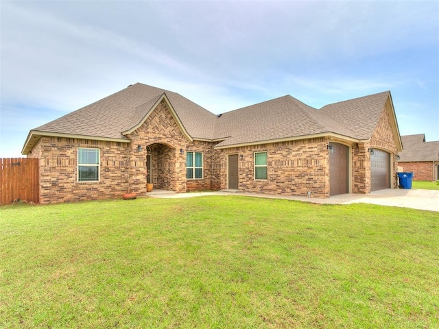 2395 County Road 1260, Blanchard, OK 73010 - french country home featuring brick siding, a shingled roof, an attached garage, and concrete driveway