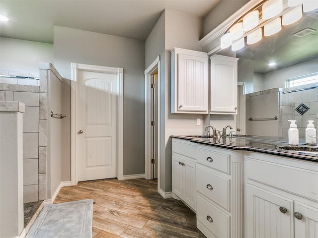 2395 County Road 1260, Blanchard, OK 73010 - bathroom with vanity, a walk in shower, and wood finished floors