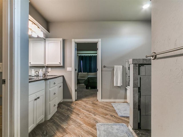 2395 County Road 1260, Blanchard, OK 73010 - full bath featuring vanity, wood finished floors, and connected bathroom