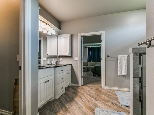 2395 County Road 1260, Blanchard, OK 73010 - ensuite bathroom with vanity and wood finished floors