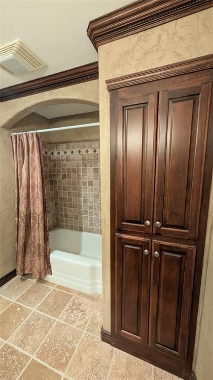3957 N 58th Ter, Oklahoma City, OK 73112 - bathroom featuring shower / bath combo and ornamental molding