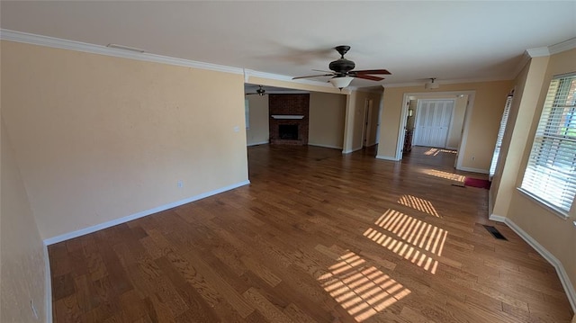 3957 N 58th Ter, Oklahoma City, OK 73112 - empty room with crown molding, a ceiling fan, a brick fireplace, and wood finished floors