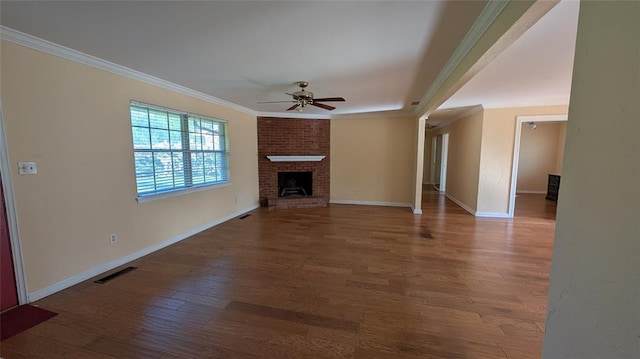 3957 N 58th Ter, Oklahoma City, OK 73112 - unfurnished living room featuring a ceiling fan, ornamental molding, wood finished floors, and a fireplace