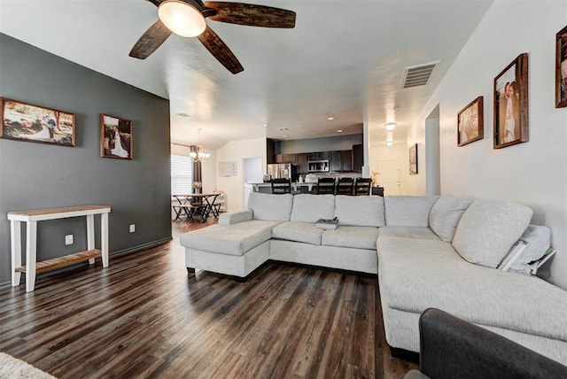 11704 NW 135th Ter, Piedmont, OK 73078 - living room featuring dark wood finished floors, a ceiling fan, and a chandelier