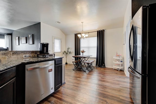 11704 NW 135th Ter, Piedmont, OK 73078 - kitchen featuring freestanding refrigerator, dishwasher, a chandelier, healthy amount of natural light, and lofted ceiling