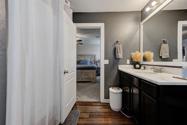 11704 NW 135th Ter, Piedmont, OK 73078 - ensuite bathroom featuring wood finished floors, vanity, and ceiling fan