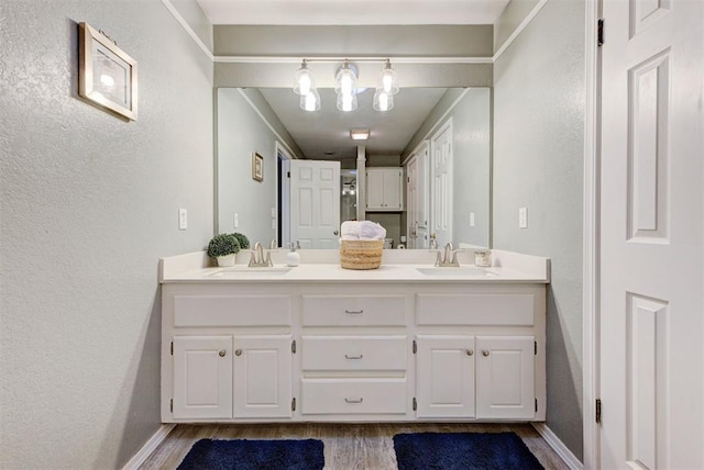 8517 SW 36th Ter, Oklahoma City, OK 73179 - full bath featuring wood finished floors, double vanity, and a textured wall