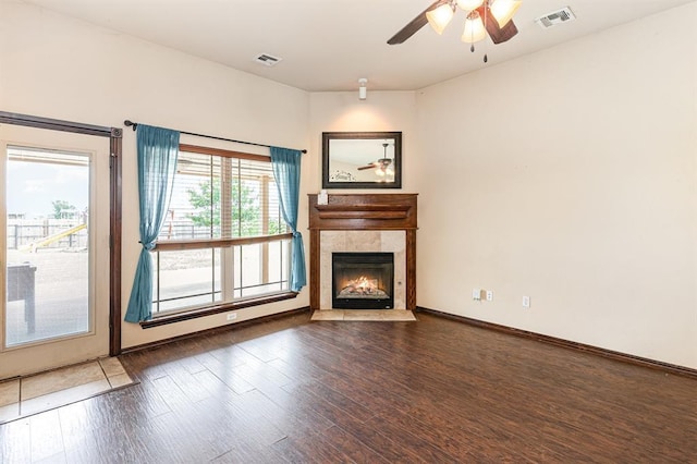 2524 Faint Ridge Way, Piedmont, OK 73078 - unfurnished living room with wood finished floors, a tiled fireplace, and ceiling fan