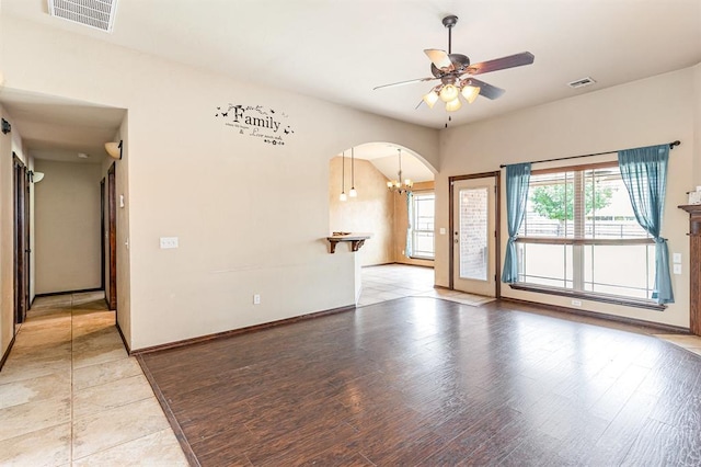 2524 Faint Ridge Way, Piedmont, OK 73078 - unfurnished room with arched walkways, a ceiling fan, a chandelier, and light wood-style flooring