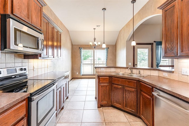2524 Faint Ridge Way, Piedmont, OK 73078 - kitchen with appliances with stainless steel finishes, healthy amount of natural light, decorative backsplash, and light tile patterned floors