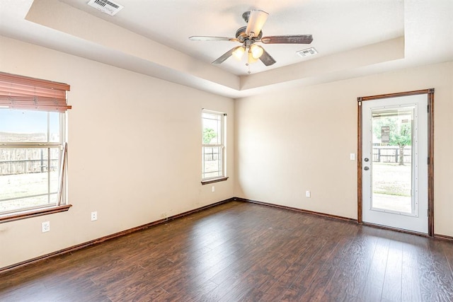2524 Faint Ridge Way, Piedmont, OK 73078 - empty room featuring a raised ceiling, dark wood-style floors, and ceiling fan