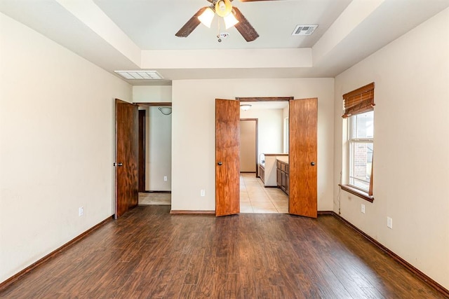 2524 Faint Ridge Way, Piedmont, OK 73078 - empty room featuring a ceiling fan, wood finished floors, and a raised ceiling