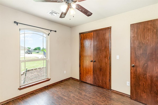 2524 Faint Ridge Way, Piedmont, OK 73078 - unfurnished bedroom featuring multiple windows, wood finished floors, and ceiling fan