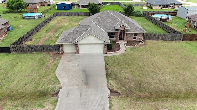 2524 Faint Ridge Way, Piedmont, OK 73078 - view of front of house featuring brick siding, a garage, driveway, and a fenced backyard