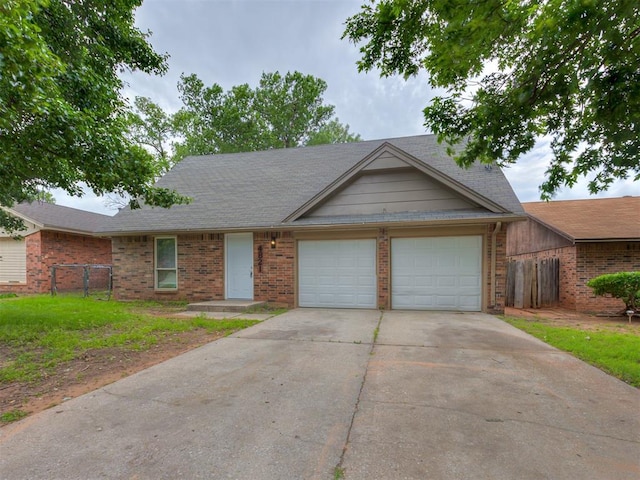 4821 Cinderella Dr, Oklahoma City, OK 73129 - view of front of home with brick siding, an attached garage, and concrete driveway