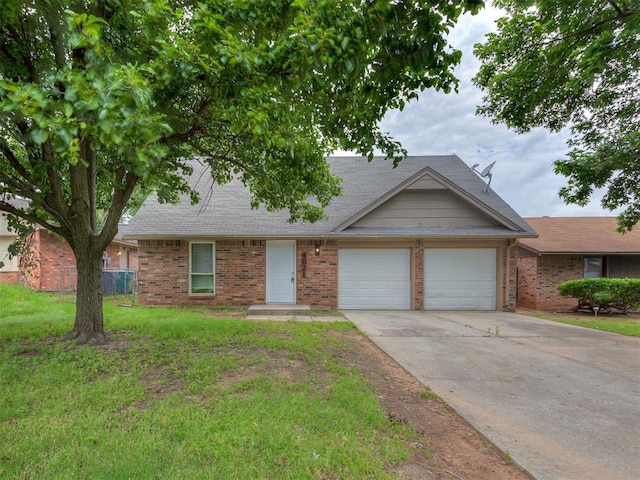 4821 Cinderella Dr, Oklahoma City, OK 73129 - view of property with a garage, brick siding, and driveway