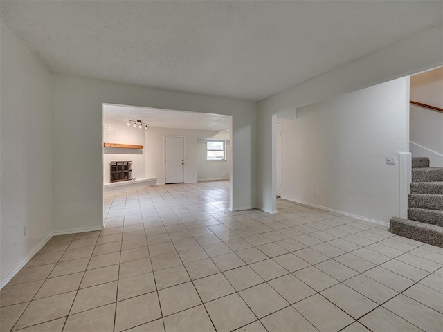4821 Cinderella Dr, Oklahoma City, OK 73129 - unfurnished living room featuring light tile patterned floors, stairway, and a chandelier