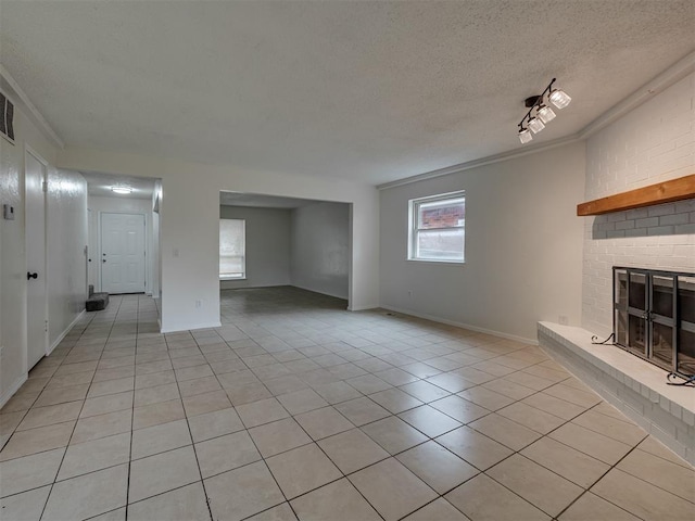 4821 Cinderella Dr, Oklahoma City, OK 73129 - unfurnished living room featuring light tile patterned flooring, a fireplace, a textured ceiling, and crown molding