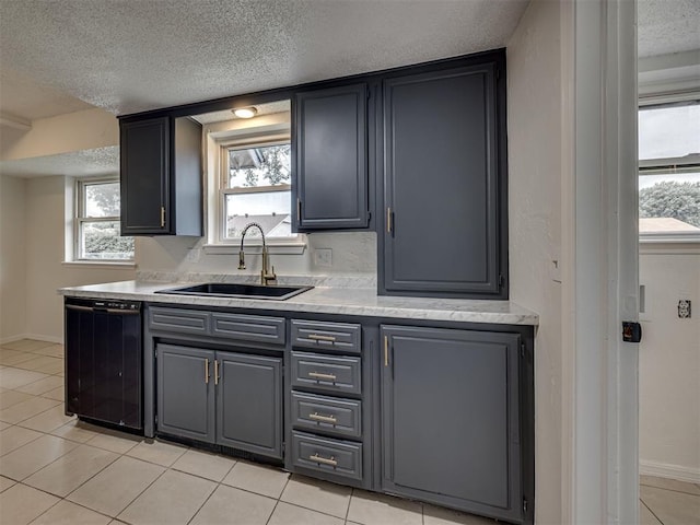 4821 Cinderella Dr, Oklahoma City, OK 73129 - kitchen featuring dishwasher, a textured ceiling, light tile patterned flooring, light countertops, and gray cabinets