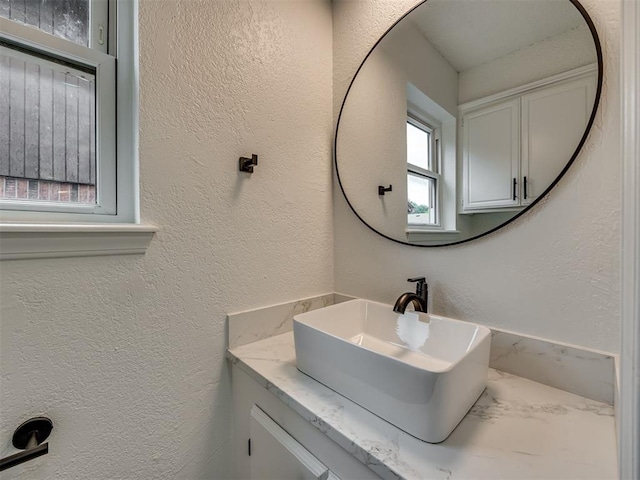 4821 Cinderella Dr, Oklahoma City, OK 73129 - bathroom featuring vanity and a textured wall