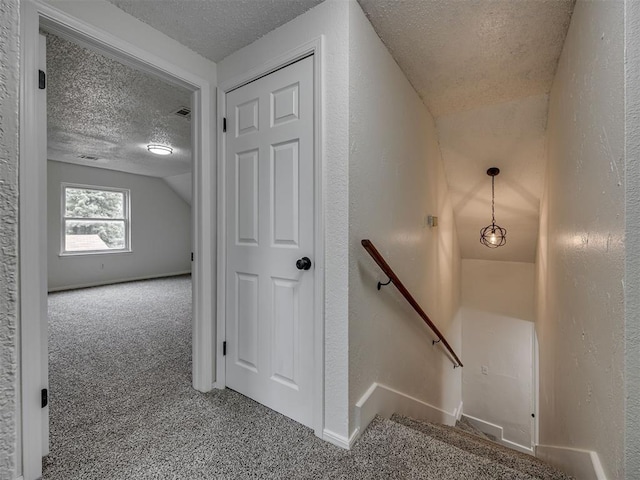 4821 Cinderella Dr, Oklahoma City, OK 73129 - stairway with a textured ceiling, carpet, lofted ceiling, and a textured wall