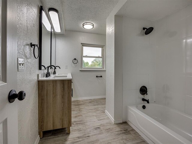 4821 Cinderella Dr, Oklahoma City, OK 73129 - full bathroom with vanity, wood finished floors, shower / bathtub combination, and a textured wall