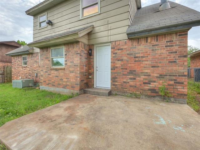 4821 Cinderella Dr, Oklahoma City, OK 73129 - rear view of house featuring brick siding and a patio area