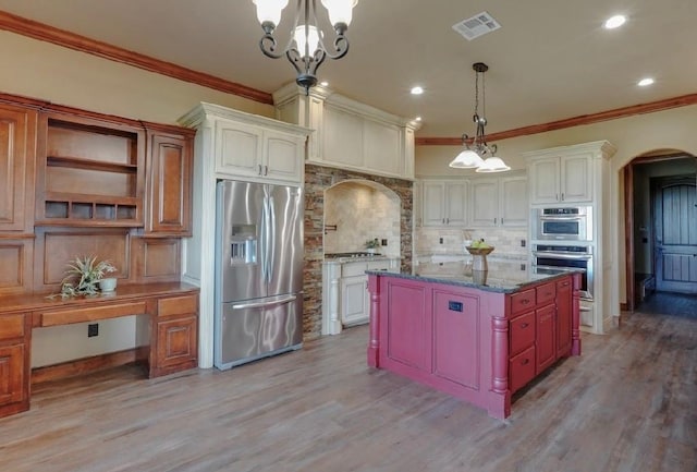 30202 Sleepy Hollow Dr, Mcloud, OK 74851 - kitchen featuring appliances with stainless steel finishes, arched walkways, tasteful backsplash, ornamental molding, and light wood-style flooring