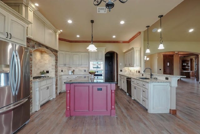 30202 Sleepy Hollow Dr, Mcloud, OK 74851 - kitchen featuring stainless steel appliances, arched walkways, a peninsula, tasteful backsplash, and recessed lighting
