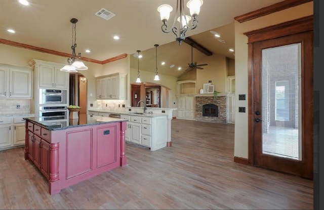 30202 Sleepy Hollow Dr, Mcloud, OK 74851 - kitchen with open floor plan, a fireplace, tasteful backsplash, a peninsula, and a ceiling fan