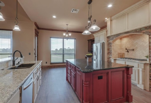 30202 Sleepy Hollow Dr, Mcloud, OK 74851 - kitchen featuring stainless steel appliances, light wood-style floors, decorative backsplash, ornamental molding, and a chandelier