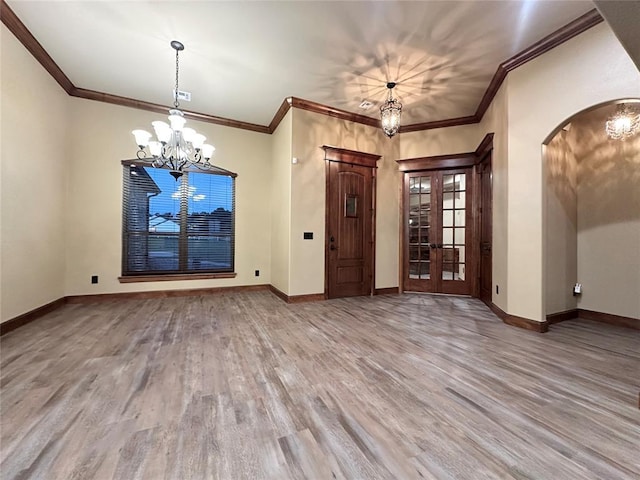 30202 Sleepy Hollow Dr, Mcloud, OK 74851 - foyer entrance featuring a chandelier, wood finished floors, arched walkways, ornamental molding, and french doors