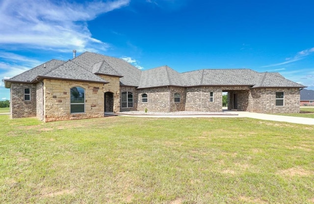 30202 Sleepy Hollow Dr, Mcloud, OK 74851 - french provincial home featuring a front yard, brick siding, and roof with shingles