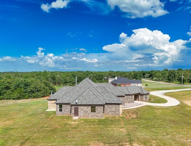 30202 Sleepy Hollow Dr, Mcloud, OK 74851 - view of front of house featuring stone siding, a front yard, and a view of trees