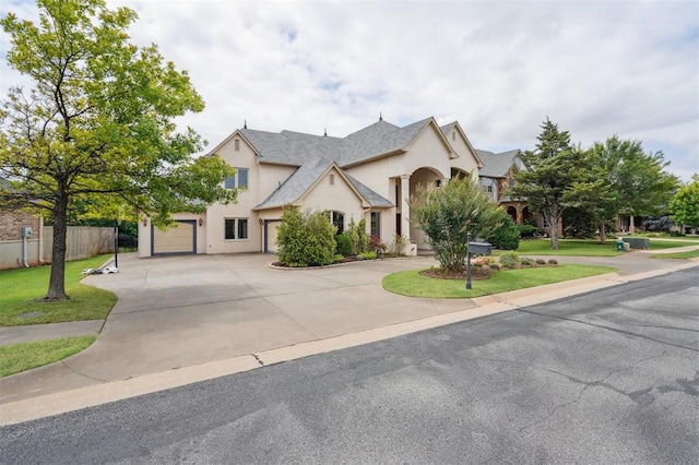 13209 Blue Canyon Cir, Oklahoma City, OK 73142 - view of front of house with curved driveway, stucco siding, and an attached garage