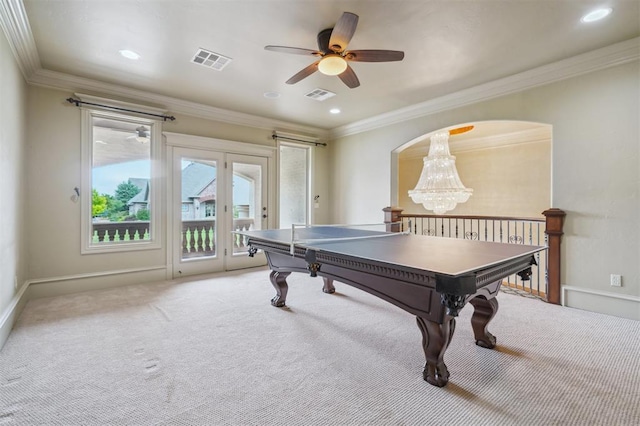 13209 Blue Canyon Cir, Oklahoma City, OK 73142 - recreation room featuring light carpet, crown molding, a chandelier, a ceiling fan, and arched walkways
