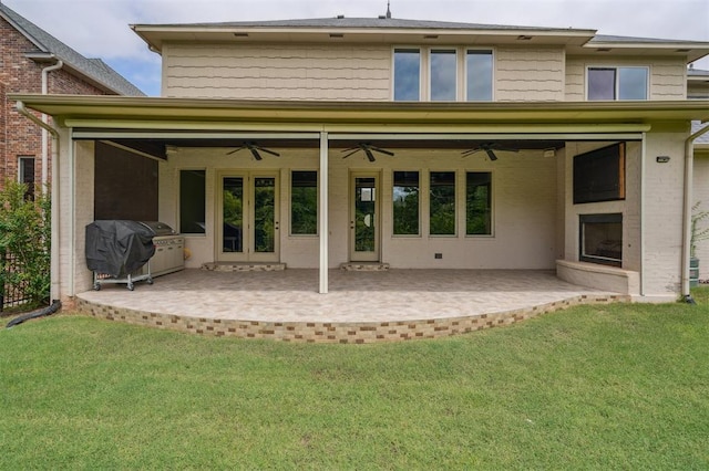 13209 Blue Canyon Cir, Oklahoma City, OK 73142 - back of house with a ceiling fan, a patio area, and a yard