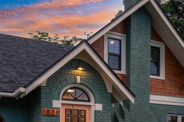 1828 S 7th St, Chickasha, OK 73018 - exterior view of a chimney, brick siding, and a shingled roof