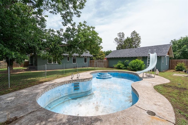 1828 S 7th St, Chickasha, OK 73018 - view of pool with a water slide and a fenced backyard