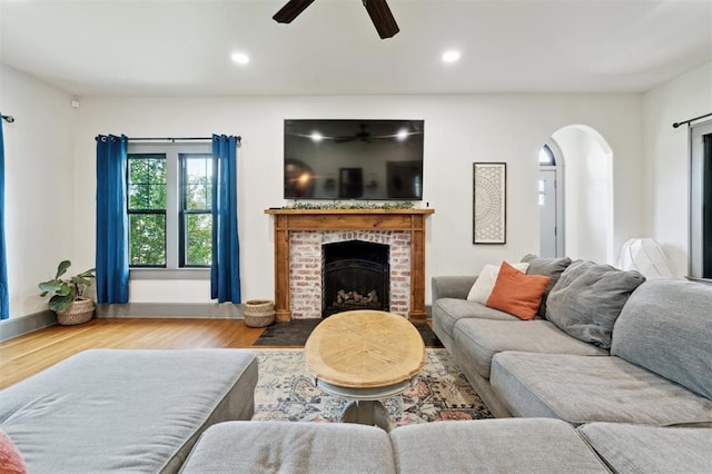 1828 S 7th St, Chickasha, OK 73018 - living room with ceiling fan, arched walkways, wood finished floors, a fireplace, and recessed lighting