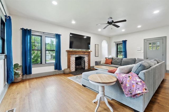 1828 S 7th St, Chickasha, OK 73018 - living area with healthy amount of natural light, wood finished floors, a brick fireplace, and recessed lighting