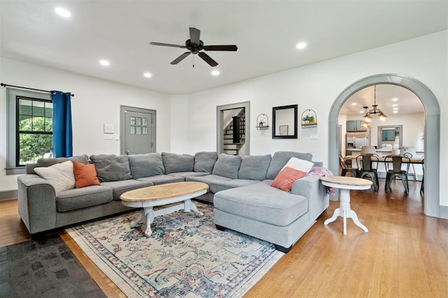 1828 S 7th St, Chickasha, OK 73018 - living area featuring arched walkways, wood finished floors, a ceiling fan, recessed lighting, and stairs