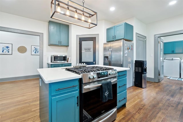 1828 S 7th St, Chickasha, OK 73018 - kitchen featuring stainless steel appliances, blue cabinets, wood finished floors, light countertops, and recessed lighting