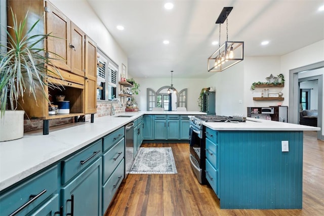 1828 S 7th St, Chickasha, OK 73018 - kitchen featuring stainless steel appliances, open shelves, blue cabinets, dark wood finished floors, and light countertops