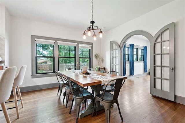 1828 S 7th St, Chickasha, OK 73018 - dining room featuring a chandelier, wood finished floors, and baseboard heating