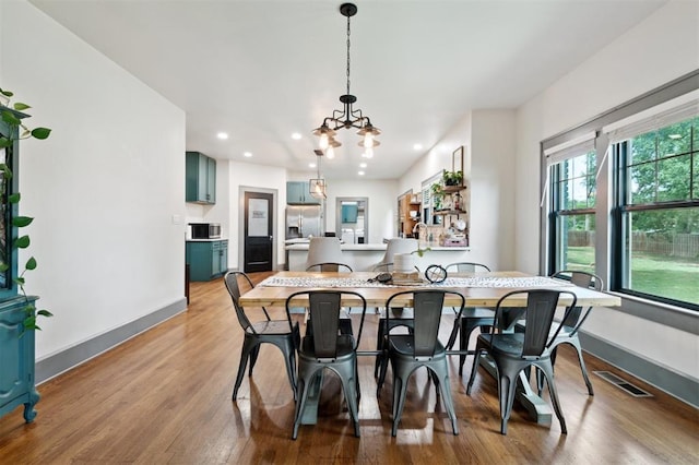 1828 S 7th St, Chickasha, OK 73018 - dining area featuring a chandelier, recessed lighting, and wood finished floors