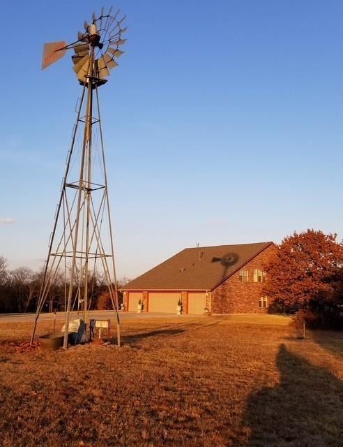 13501 E Memorial Rd, Jones, OK 73049 - back of property at dusk featuring a garage