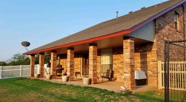 13501 E Memorial Rd, Jones, OK 73049 - back of house with brick siding and a patio area