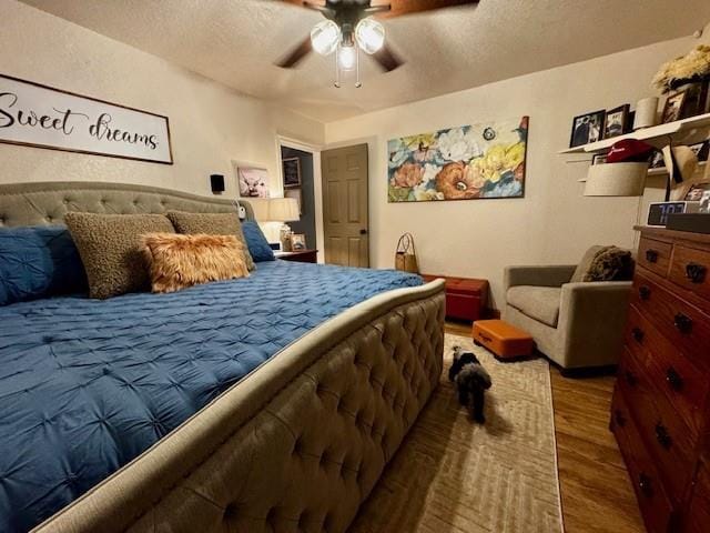 13501 E Memorial Rd, Jones, OK 73049 - bedroom featuring wood finished floors, ceiling fan, and a textured ceiling